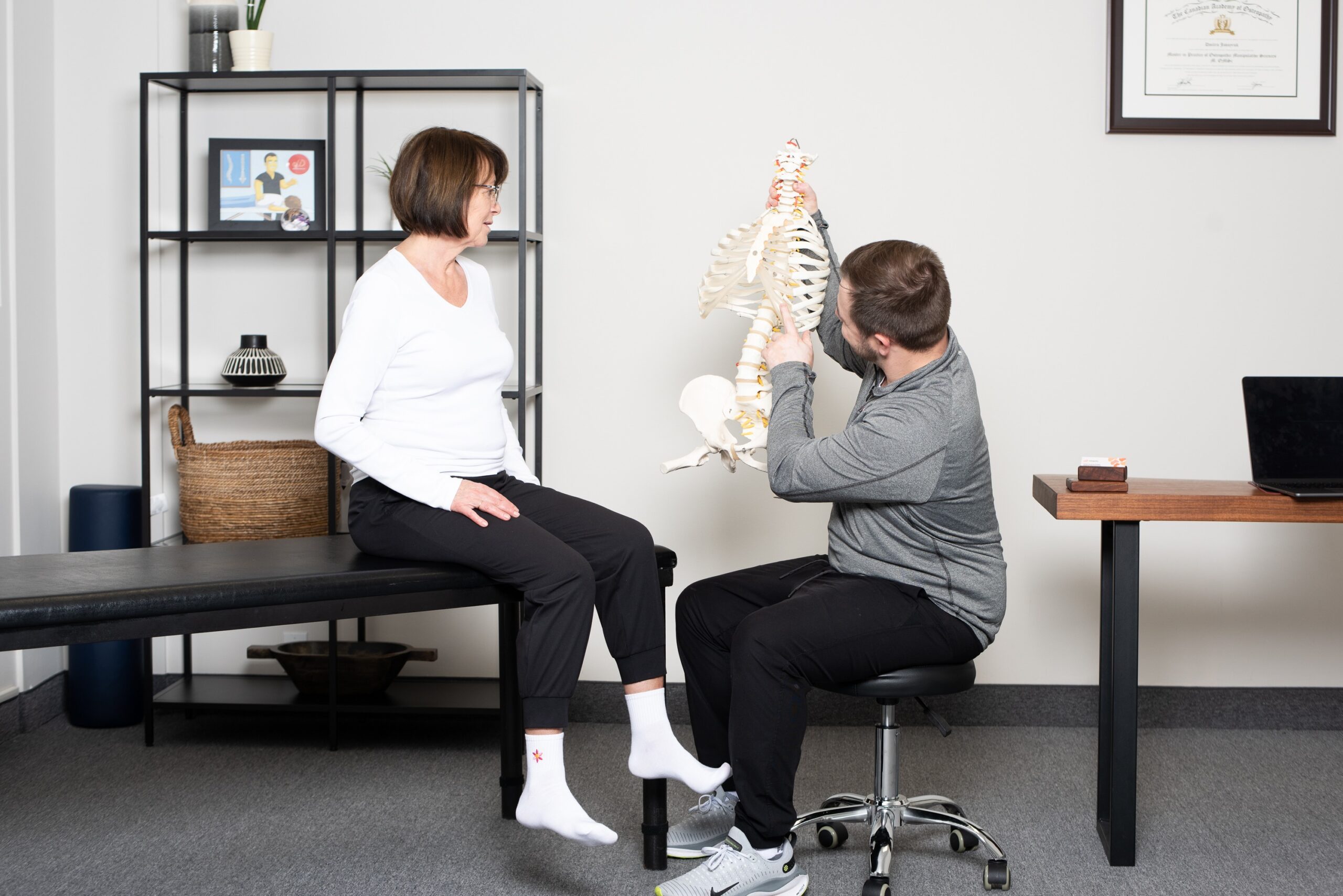 Why You Felt Worse After Osteopathy: What's Worthwhile in Mississauga 1 Dmitro Jovnyruk showing patient why you felt worse after osteopathy treatments on a skeleton.